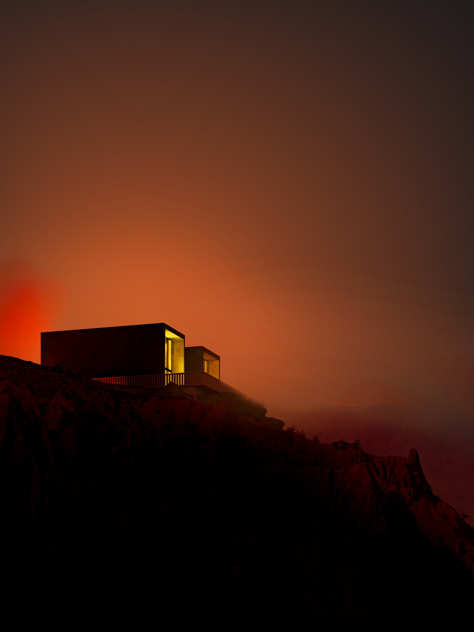 The two villas lit at last light, the sky burning over the sea