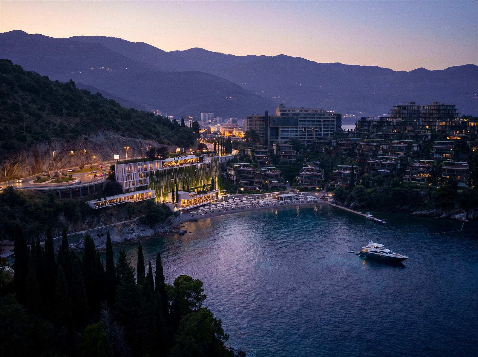 Dukley — aerial of the lit bay, resort terraces and moored yacht